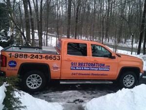 Water Damage Restoration Truck On Driveway In Winter